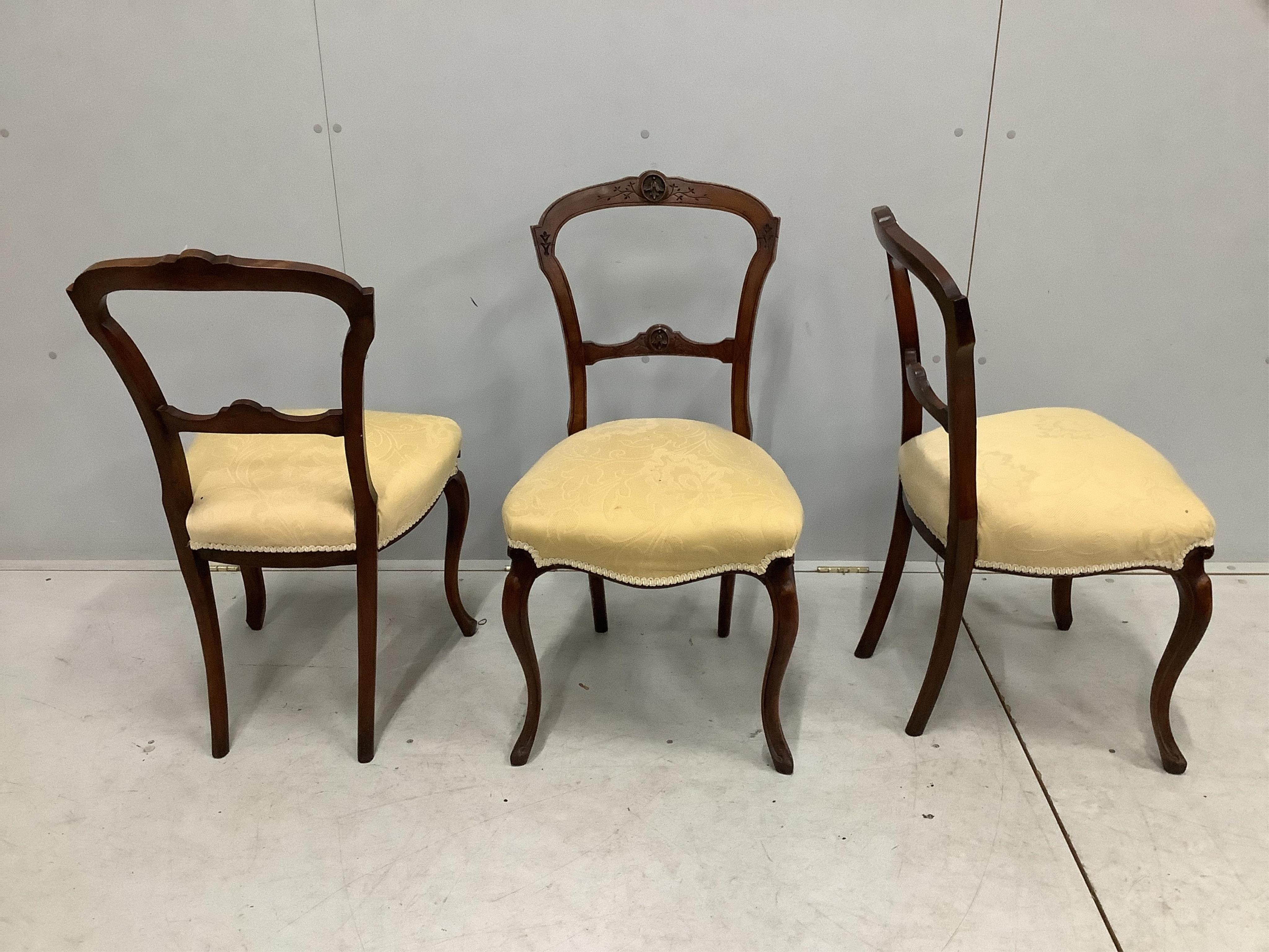 Three Victorian walnut dining chairs, on cabriole legs. Condition - fair